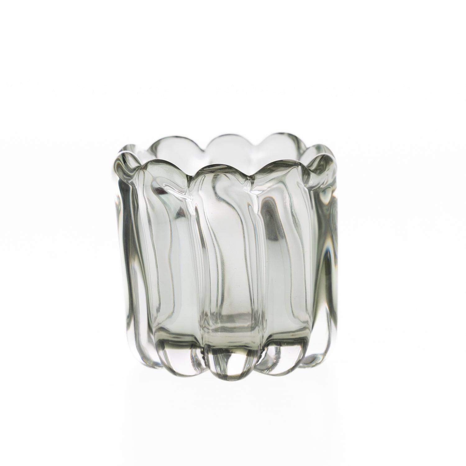 Smoked grey hand-blown glass tealight holder with a scalloped rim and sculpted ribbed design, displayed on a white background.