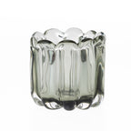 Smoked grey hand-blown glass bud vase with a scalloped rim and ribbed curved design, displayed against a white background.