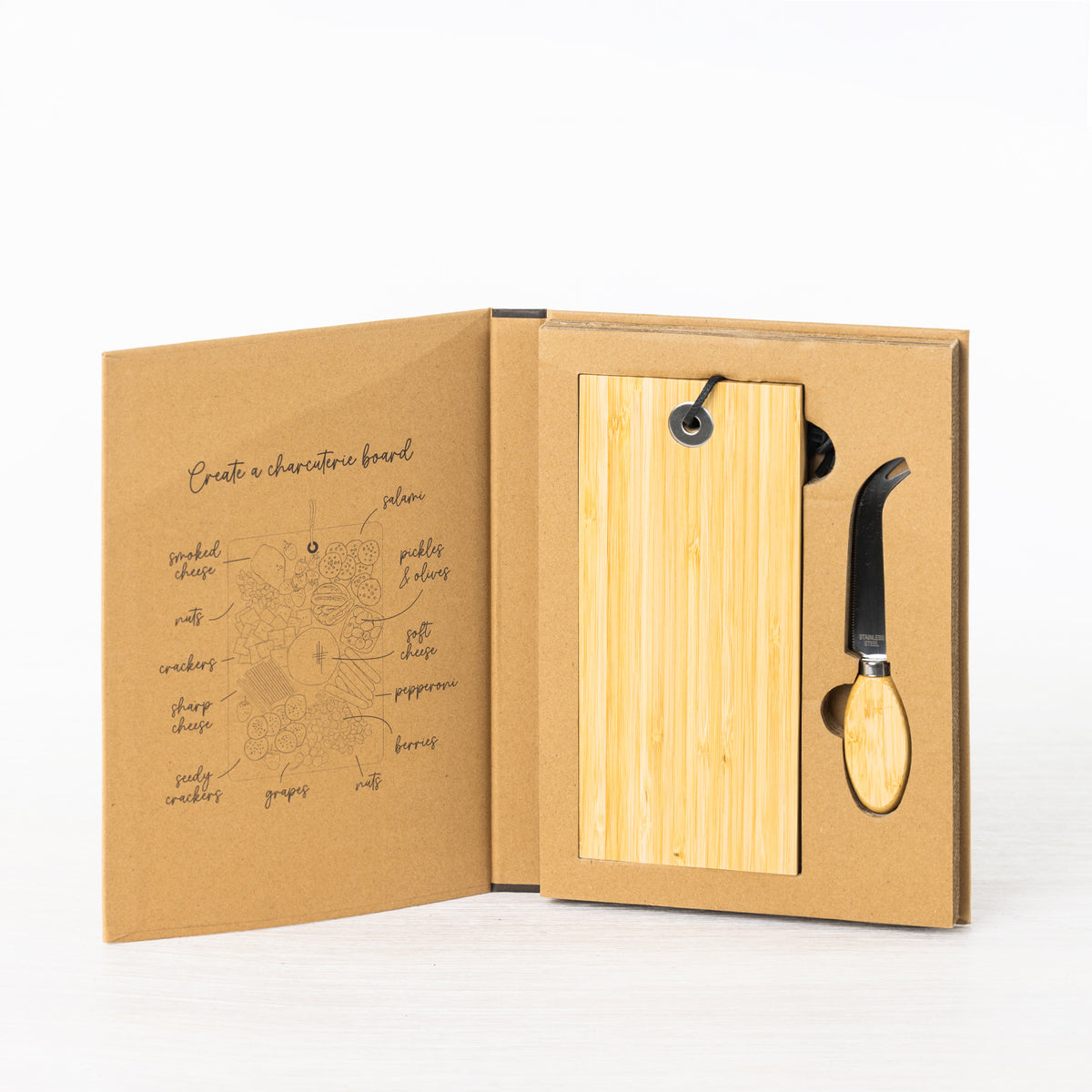 Gather 2 Piece Bamboo Board & Knife Set displayed in open gift-style packaging with a rectangular bamboo board and stainless steel cheese knife with bamboo handle.