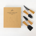Gather 4 Piece Cheese Knife Set Acacia Black featuring four black stainless steel cheese utensils with natural acacia wood handles displayed beside the packaging.