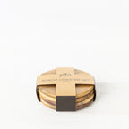 Gather 4 Piece Acacia Coaster Set featuring four stacked round acacia wood coasters secured with branded kraft cardboard packaging.