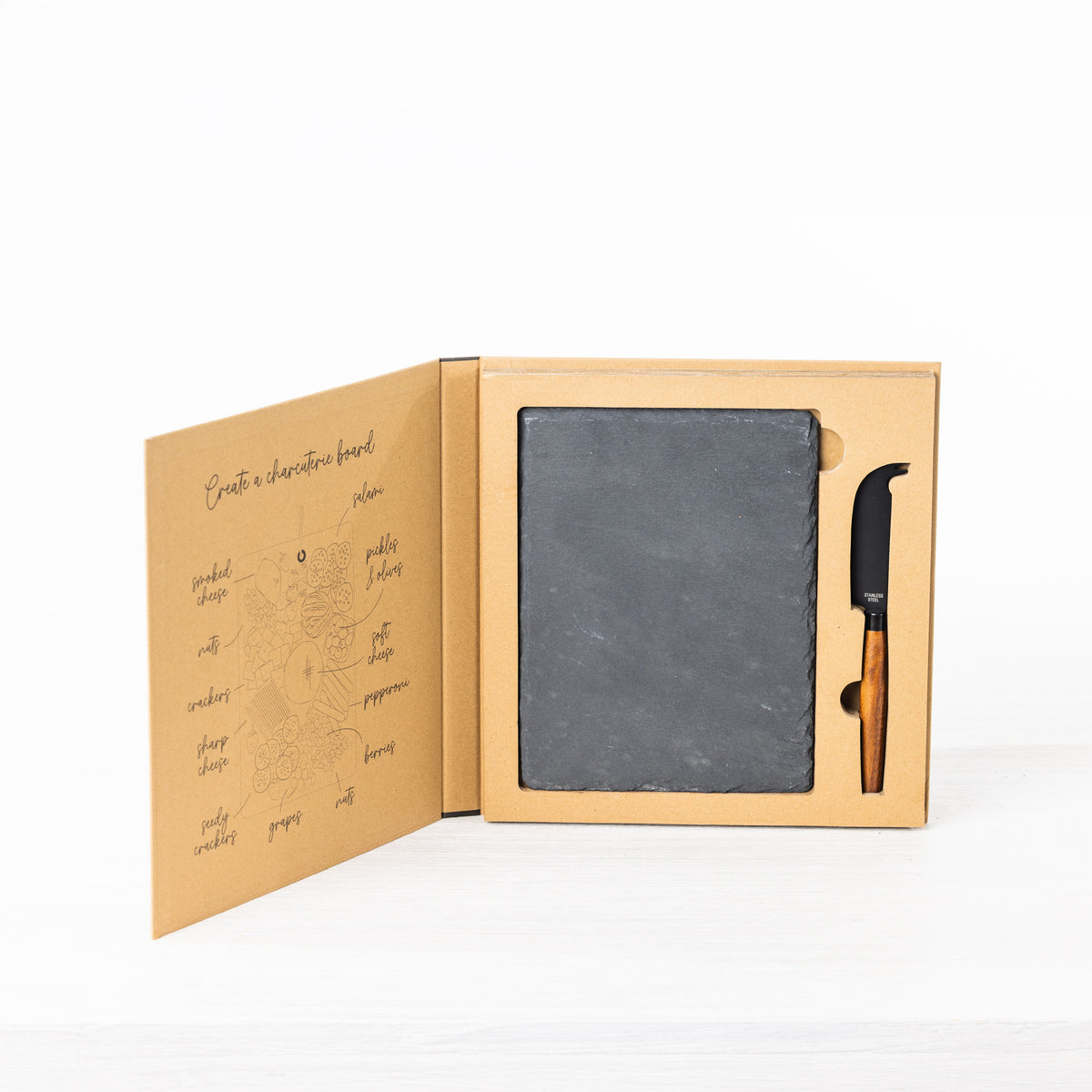Gather 2 Piece Cheese Knife & Slate Board Set displayed in open gift packaging with a square black slate board and a cheese knife with a wooden handle.