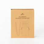 Gather Celebrate Whiskey Stone Set presented in a closed kraft cardboard gift box featuring illustrations of the whiskey stones, tongs and storage pouch.
