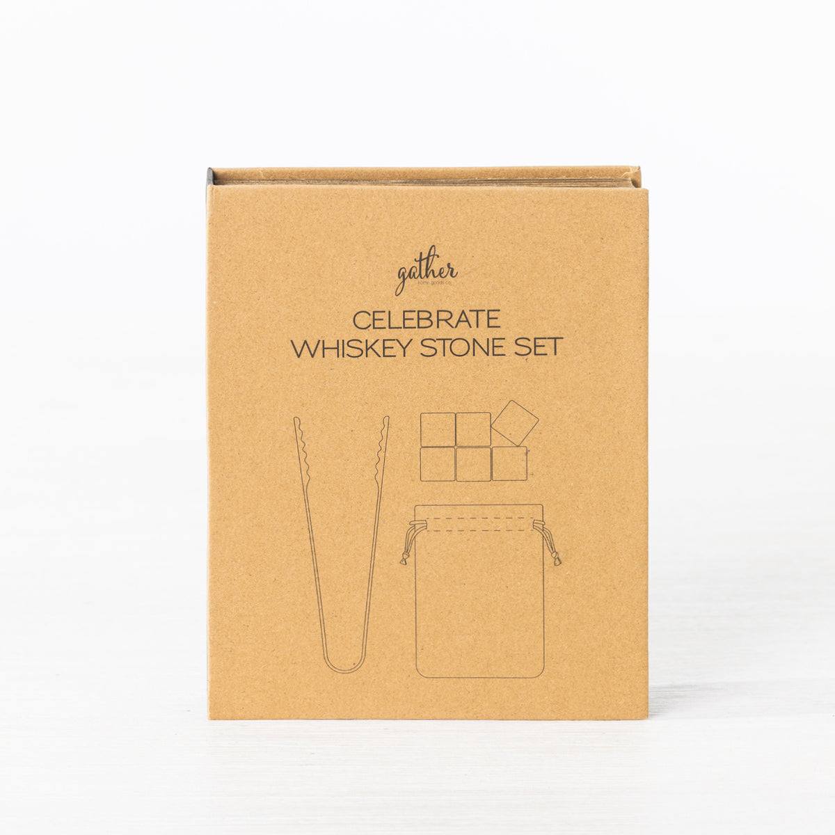 Gather Celebrate Whiskey Stone Set presented in a closed kraft cardboard gift box featuring illustrations of the whiskey stones, tongs and storage pouch.