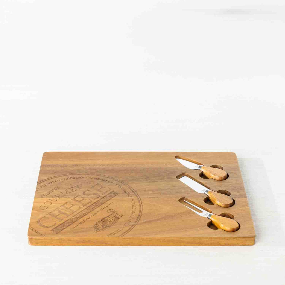 Gather 4 Piece Acacia Board & Knife Set featuring a natural acacia wood serving board with an engraved cheese design and three coordinating cheese utensils with wooden handles.