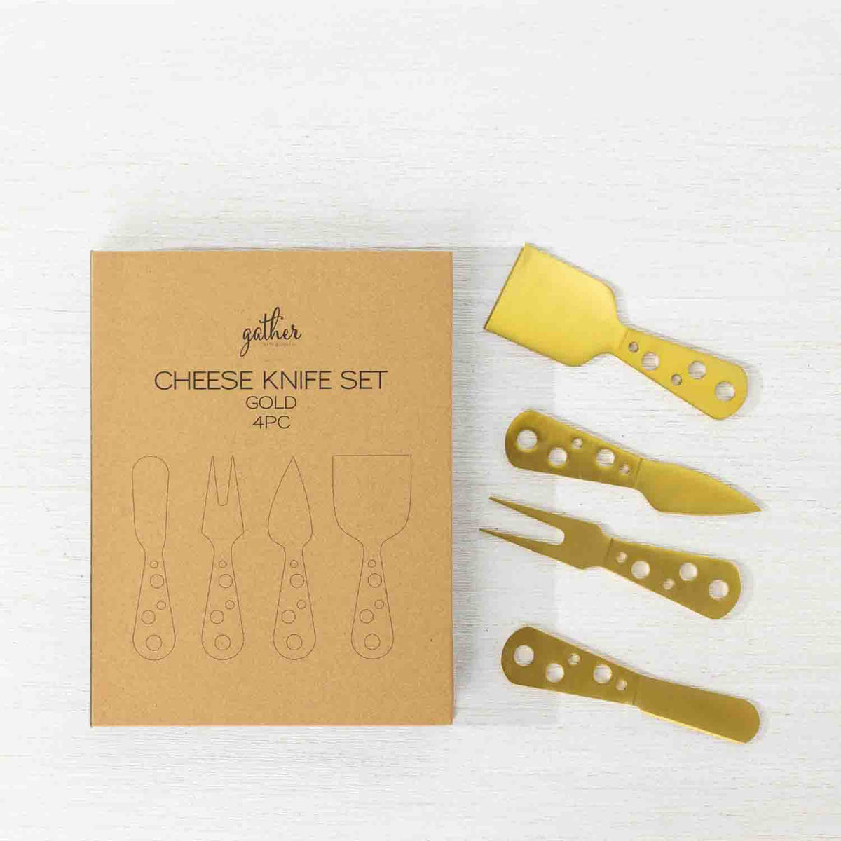 Gather 4 Piece Cheese Knife Set Gold featuring four gold-coloured cheese serving utensils with decorative circular cut-out handles displayed beside kraft cardboard packaging.