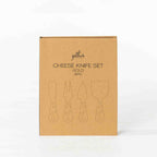 Gather 4 Piece Cheese Knife Set Gold presented in a closed kraft cardboard gift box featuring illustrations of four cheese serving utensils.