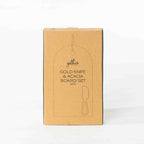 Gather 2 Piece Gold Knife & Acacia Board Set featuring a closed kraft cardboard gift box with an illustration of the acacia board and gold cheese knife.