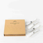 Gather 4 Piece Spreader Set White featuring four coordinating cheese spreaders with white ceramic-style handles and stainless steel blades.