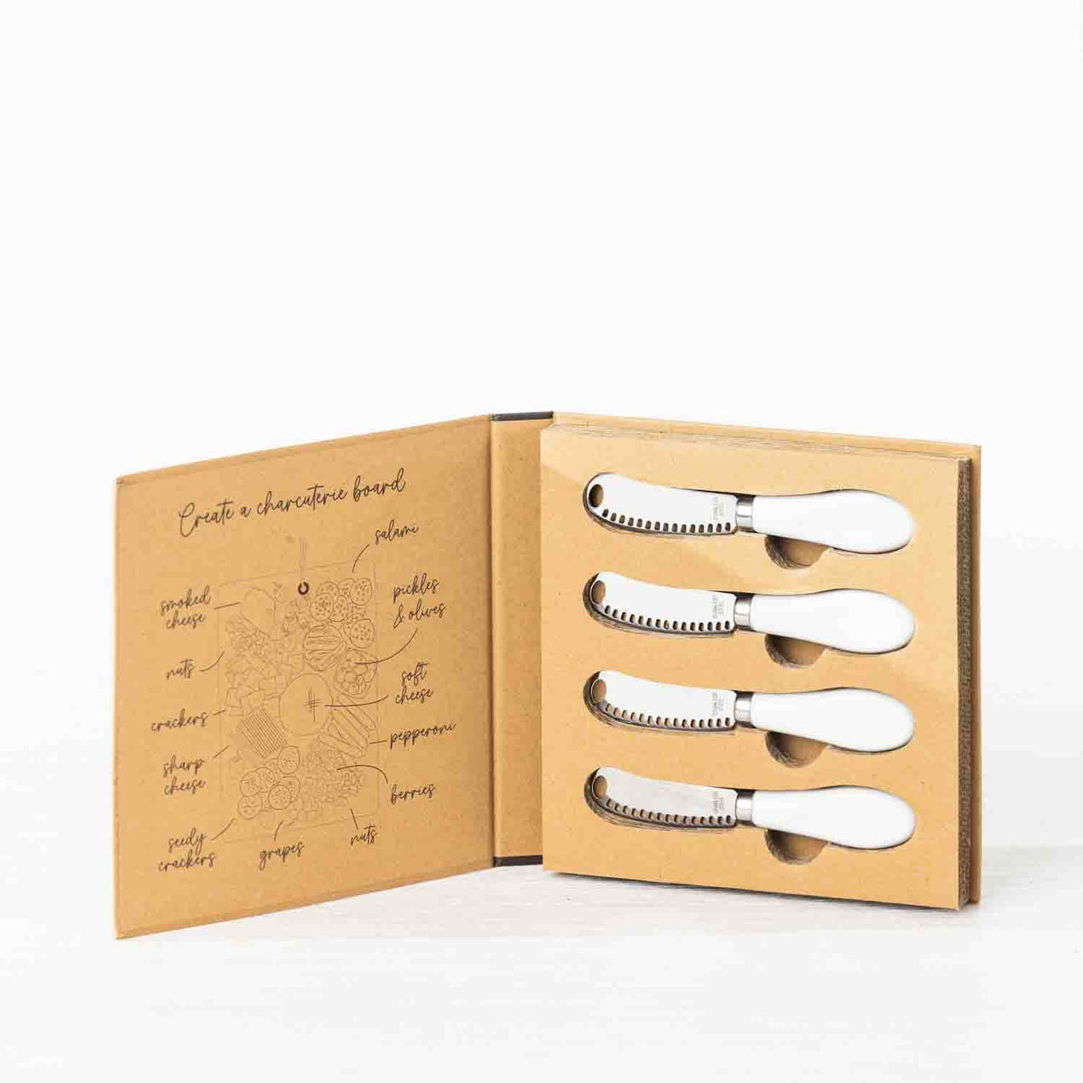 Gather 4 Piece Spreader Set White displayed in open kraft cardboard gift packaging with four matching spreaders and a charcuterie board illustration.