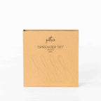 Gather 4 Piece Spreader Set White presented in a closed kraft cardboard gift box featuring illustrations of the four spreaders.