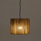 A light shade with a textured, vertically ribbed gold-toned shade, suspended by a black cord against a plain gray background.