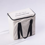 Play The Field backyard domino game packed in a natural canvas carry bag with black handles and zip closure.