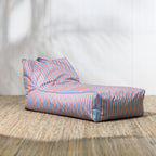 Striped bean bag chair on a wooden floor with a white wall background