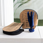 Play The Field shuttlecock hand paddle game set with two cork paddles and a blue shuttlecock displayed on a tabletop.
