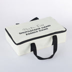Play The Field shuttlecock hand paddle game neatly packed in a white carry case with black handles and zip closure.