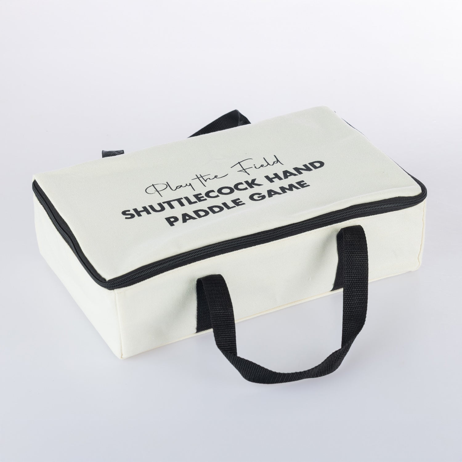 Play The Field shuttlecock hand paddle game neatly packed in a white carry case with black handles and zip closure.