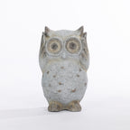 A gray stone owl figurine with textured speckled detailing and large circular eyes, standing upright against a plain white background.