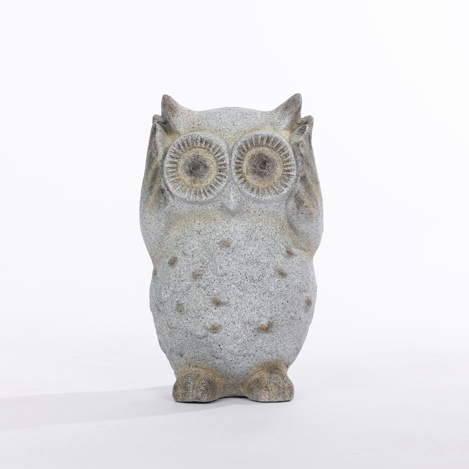 A gray stone owl figurine with textured speckled detailing and large circular eyes, standing upright against a plain white background.