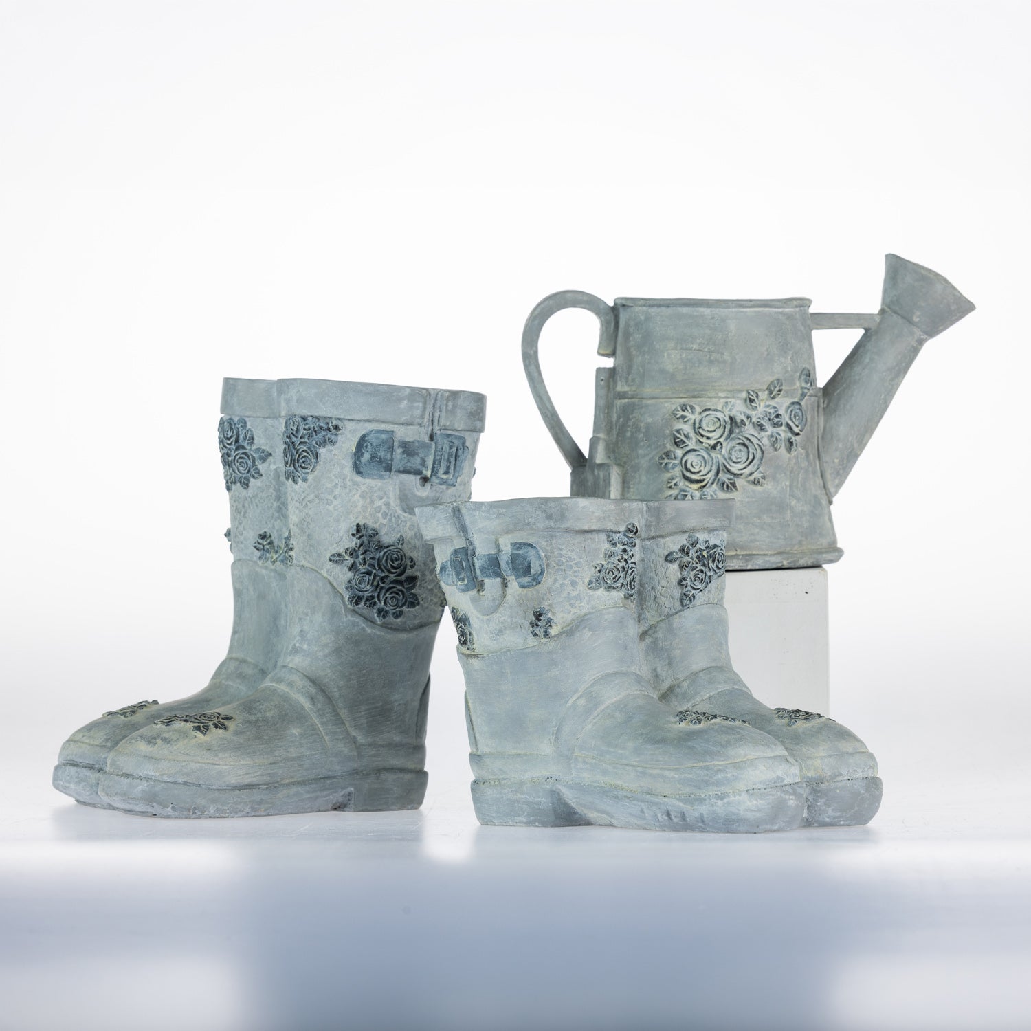 Outsidings Brynn Planter Range, showing the coordinating watering jug planter and boot-shaped planters with matching distressed grey finishes and decorative floral detailing.