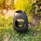 Black rain curtain LED water feature in a garden setting with flowing water and built-in LED illumination.