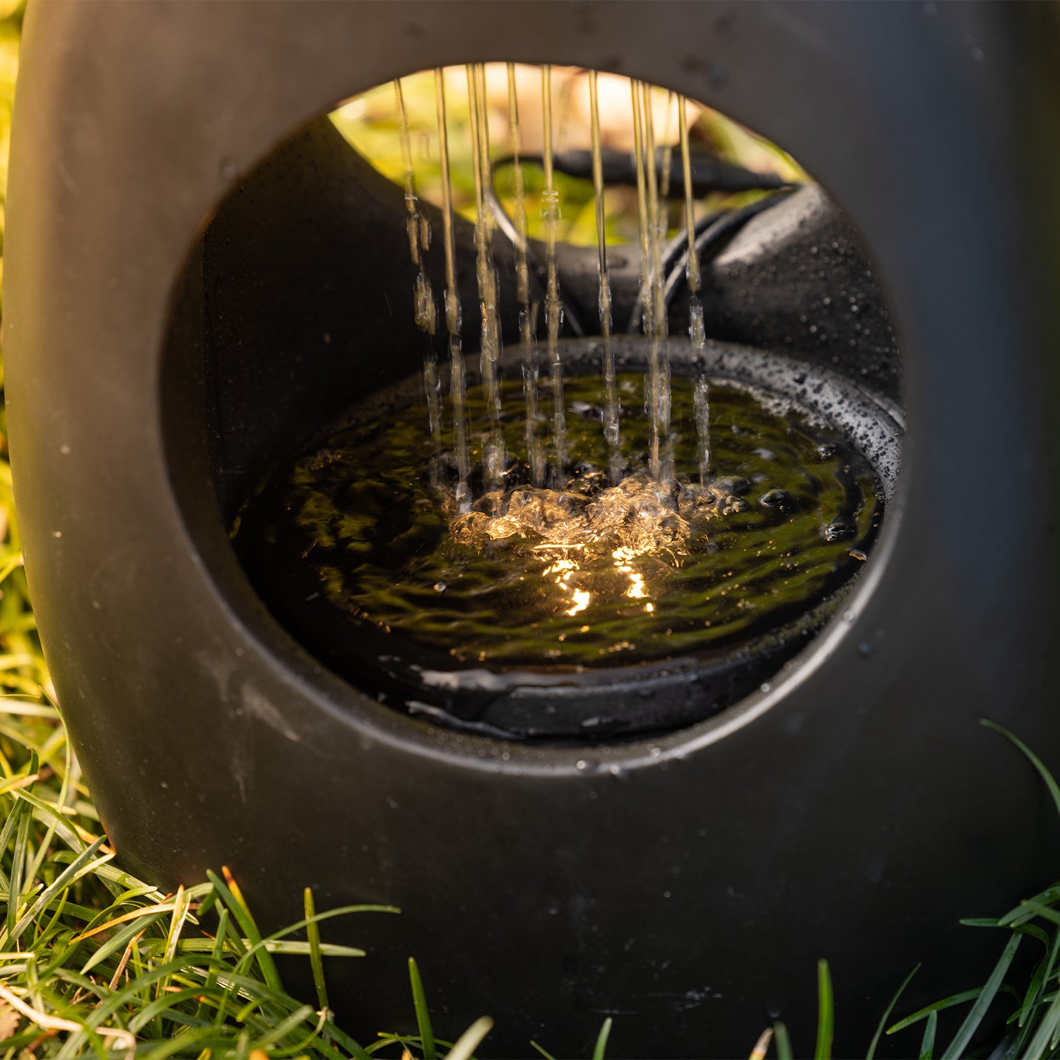 Black rain curtain LED water feature with an oval open-centre design, shown on a white background.