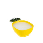 Outsidings Sultry Citronella Candle in Pineapple Yellow, featuring a bright yellow pineapple-shaped ceramic vessel with textured detailing, green leaves and white wax.