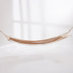 Mocha and white striped hammock suspended with wooden spreader bars against a light background.