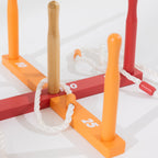 Close-up of the wooden ring toss game showing colourful scoring pegs, numbered bars and white rope rings.