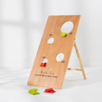 Play the Field Giant Bean Bag Toss board set up on its wooden stand with red and green bean bags ready for play.