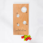 Wooden Play the Field Giant Bean Bag Toss board shown flat with four scoring holes and red and green bean bags.