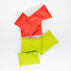 Red and green bean bags from the Play the Field Giant Bean Bag Toss game arranged together.