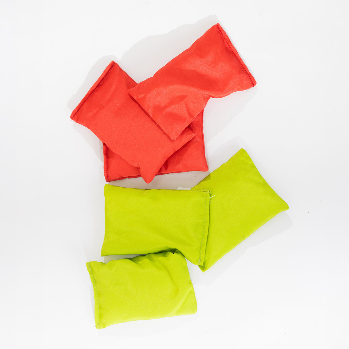 Red and green bean bags from the Play the Field Giant Bean Bag Toss game arranged together.