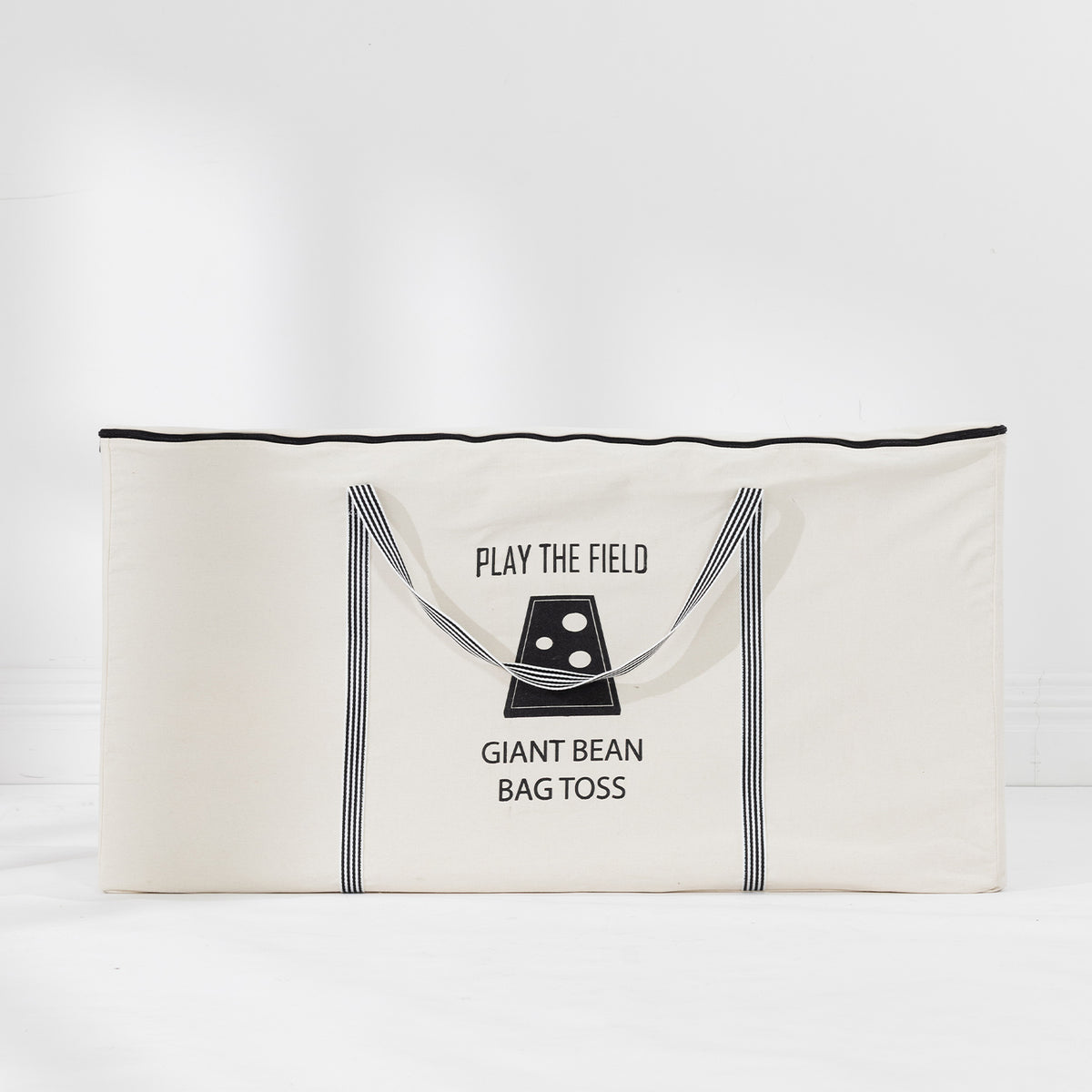 Cream Play the Field Giant Bean Bag Toss storage bag with black striped handles and printed branding.