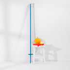 Play The Field Backyard Tetherball Game with a tall blue pole, orange tetherball, yellow tennis ball and two red racquets.