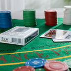 Close-up of the Play the Field Texas Card Set with poker cards and stacks of blue, green, red and white chips on the green gaming mat.