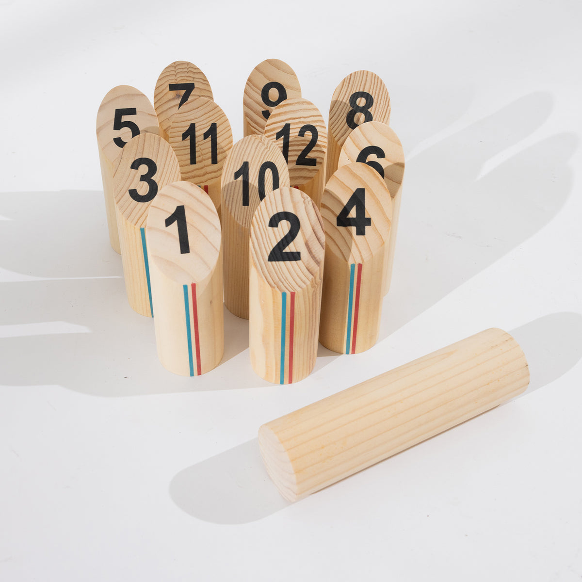 Play the Field Scattle set with 12 numbered wooden pins and a wooden throwing baton.