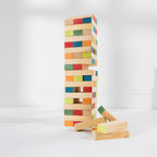 Play the Field Tumble Tower assembled with colourful wooden blocks and several loose blocks displayed beside it.