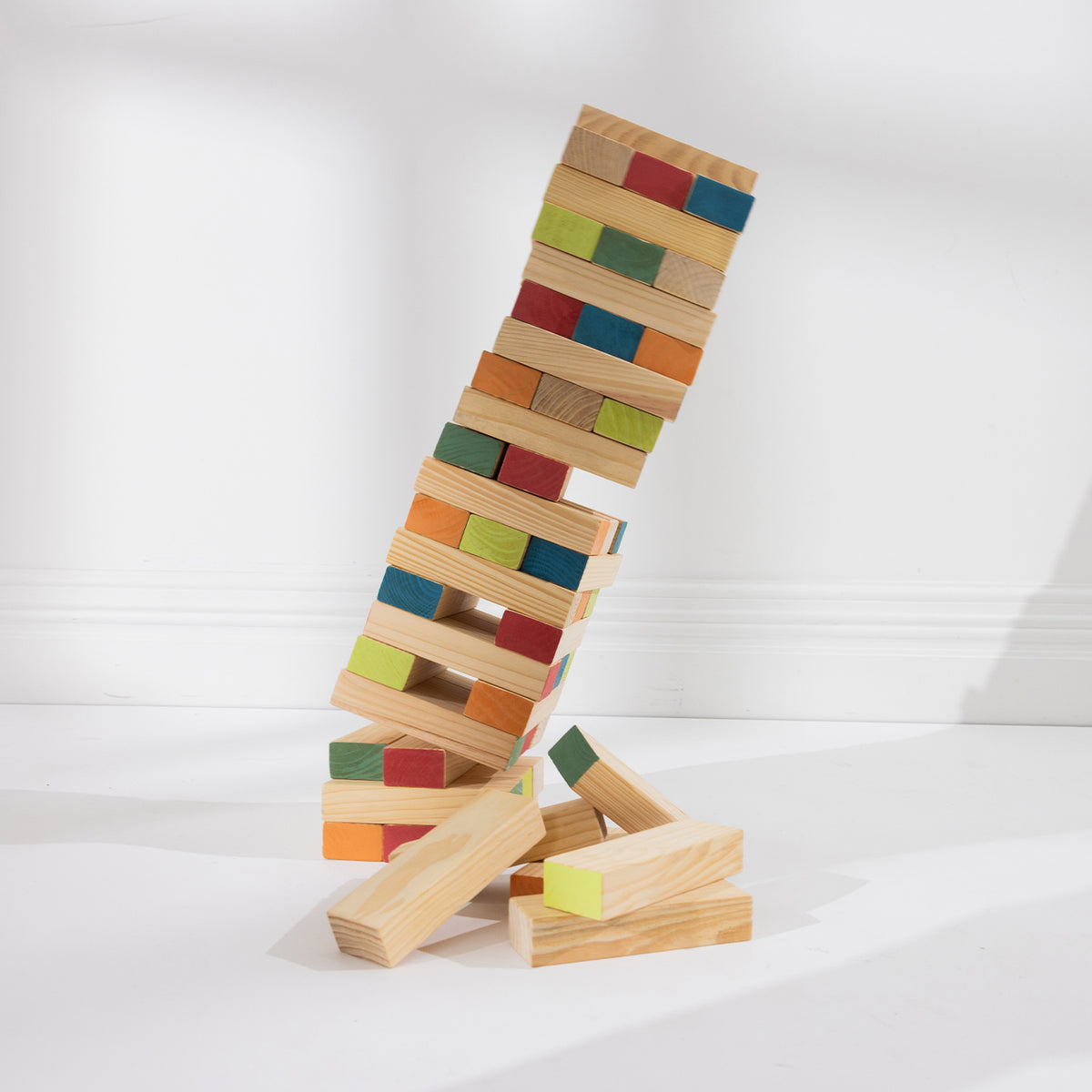 Play the Field Tumble Tower stacked wooden blocks leaning as the tower begins to tumble.