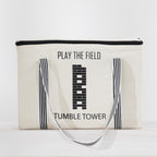Play the Field Tumble Tower cream storage bag with black striped handles and printed tower design.