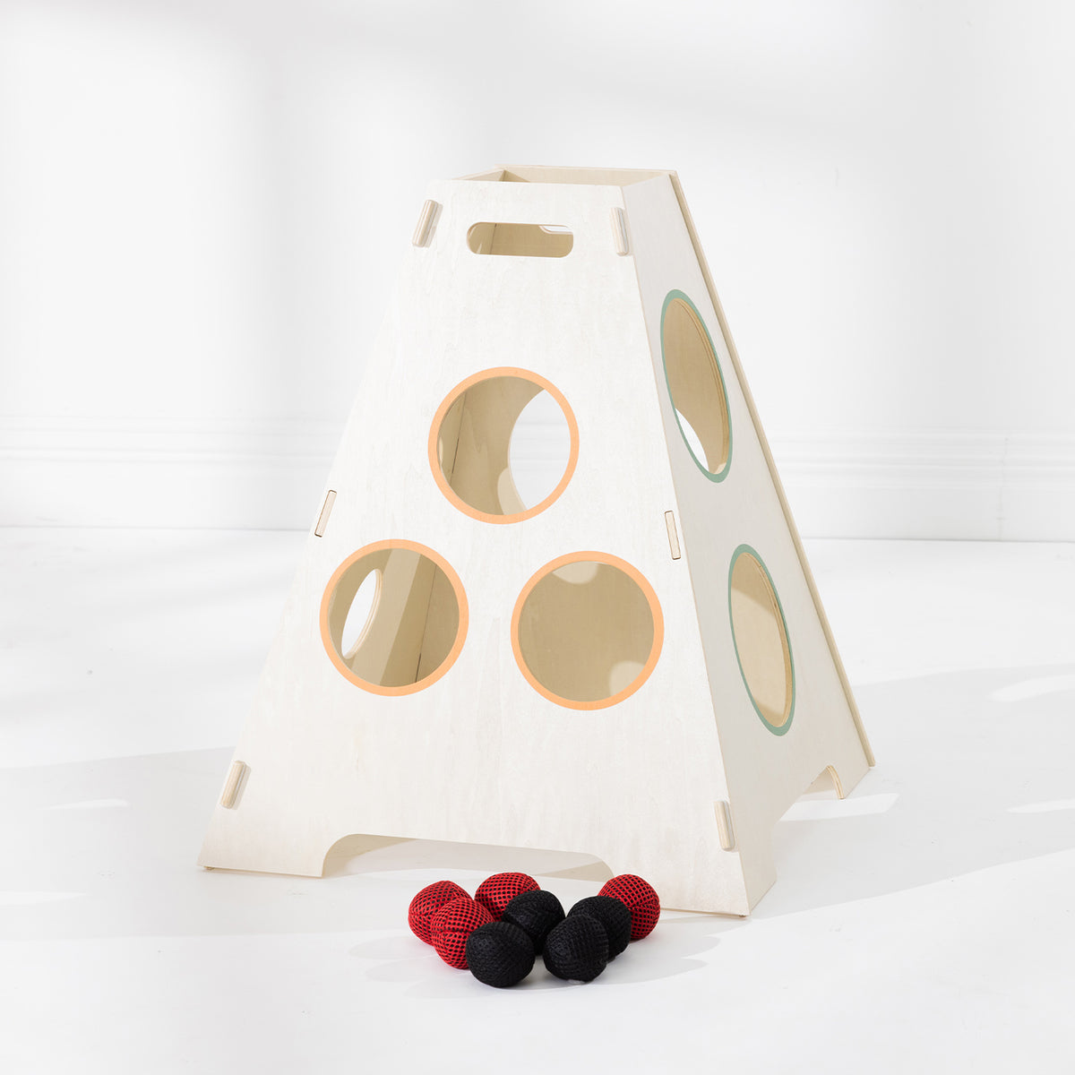 Play the Field Tower Ball wooden target tower with coloured throwing holes and red and black balls displayed in front.