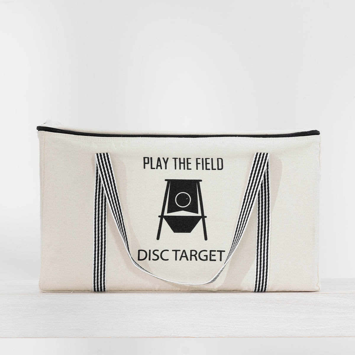 Play the Field Disc Target Game packed in a cream zippered carry bag with black handles and printed detailing.
