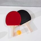 Play the Field Table Tennis Set with one red paddle, one black paddle and an orange table tennis ball displayed beneath the net.