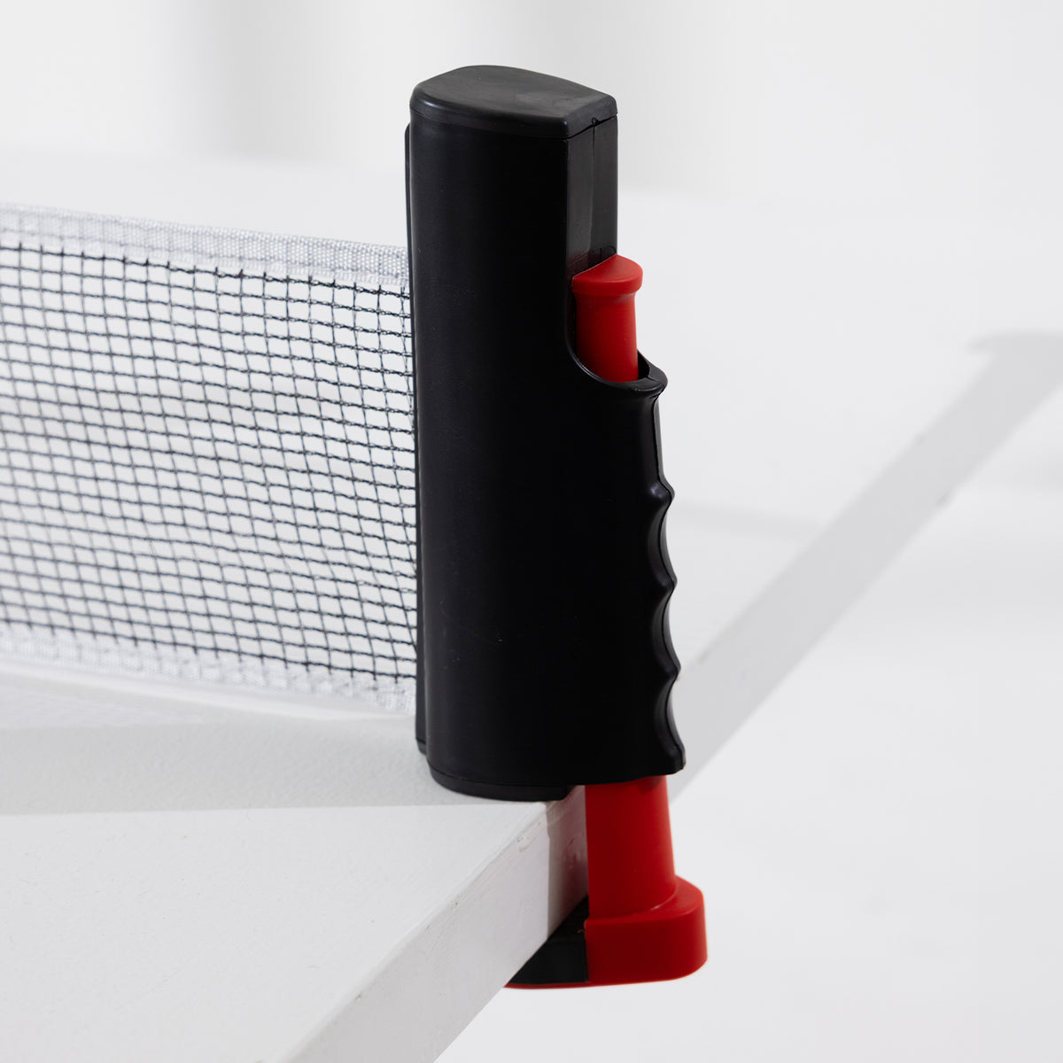 Close-up of the Play the Field Table Tennis Set adjustable net post clamped securely to the edge of a table.