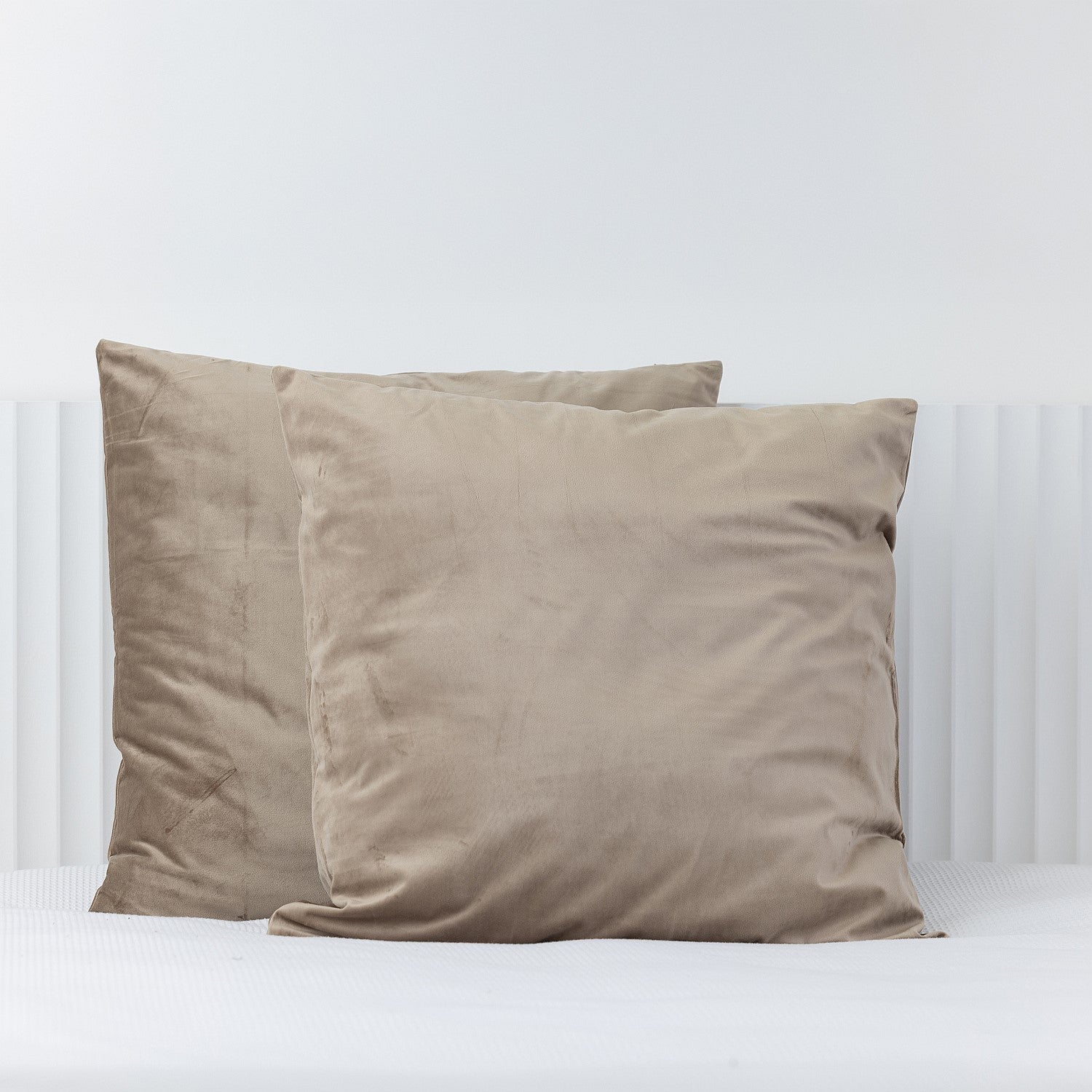 Mocha European velvet pillowcases styled on a white bed.
