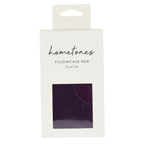 A white retail package labeled “hometones Pillowcase Pair 73 × 47 cm” features a window displaying a plum fabric sample against a plain light background.