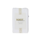 A beautifully packaged pair of white 1000 thread count cotton pillowcases is presented with a reusable branded storage band and elegant sleeve, reflecting timeless luxury and thoughtful design.