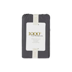 A beautifully packaged pair of charcoal 1000 thread count cotton European pillowcases is presented with a reusable branded storage band and elegant sleeve, reflecting timeless luxury and thoughtful design.