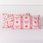 Christmas Wishes Candy Cane Christmas Pillowcase Pair featuring festive red and pink candy canes, peppermint swirls, bows and decorative stripes on a soft pink background.