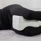 Aloe Vera memory foam leg pillow positioned between the knees to support side sleeping alignment.